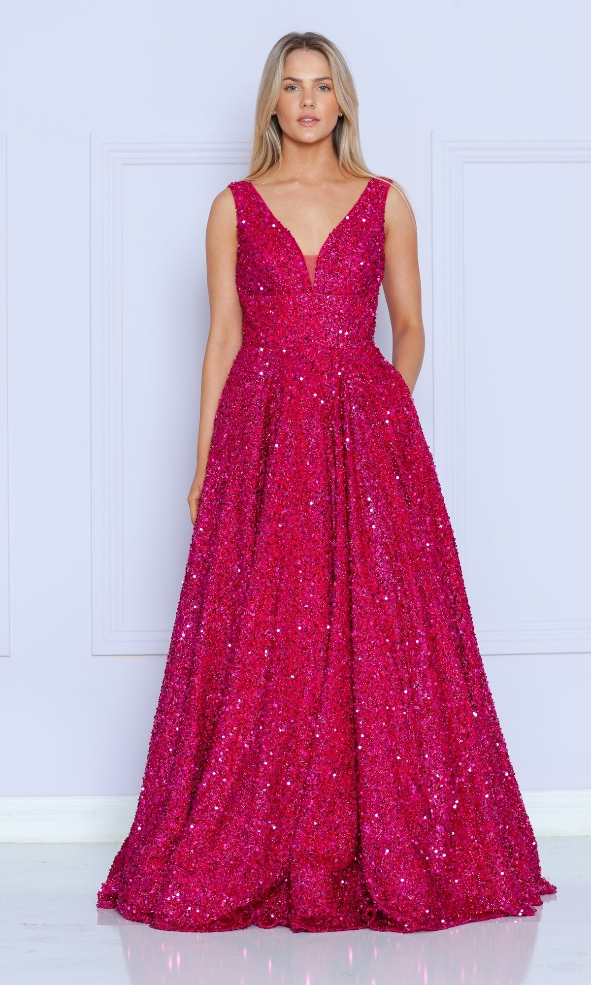 A woman stands against a light background wearing the Long Black Sequin A-Line Prom Dress 9168, a floor-length, sleeveless gown featuring sparkling sequins and an elegant A-line silhouette.